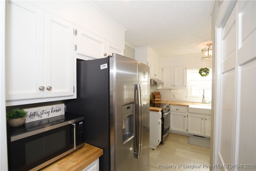 210 Tartan Road Lumberton, NC 28358 - Photo 17 of 38 a kitchen with stainless steel appliances a refrigerator stove and sink