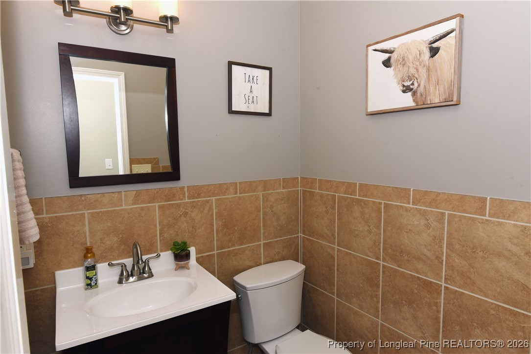 210 Tartan Road Lumberton, NC 28358 - Photo 20 of 38 a bathroom with a toilet sink and mirror