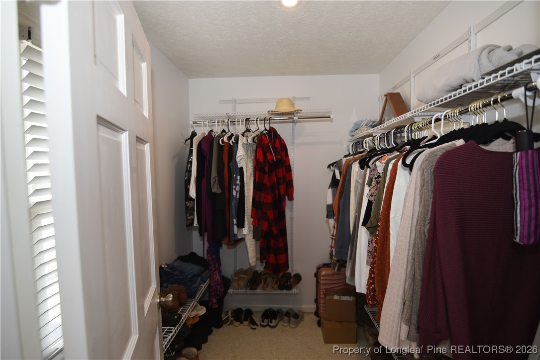 210 Tartan Road Lumberton, NC 28358 - Photo 23 of 38 a view of walk in closet with clothes and shoes
