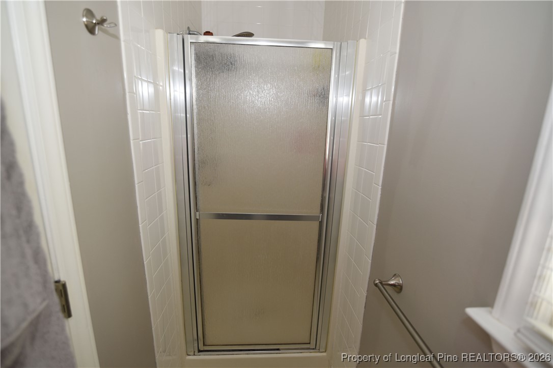 210 Tartan Road Lumberton, NC 28358 - Photo 26 of 38 a bathroom with a glass shower door