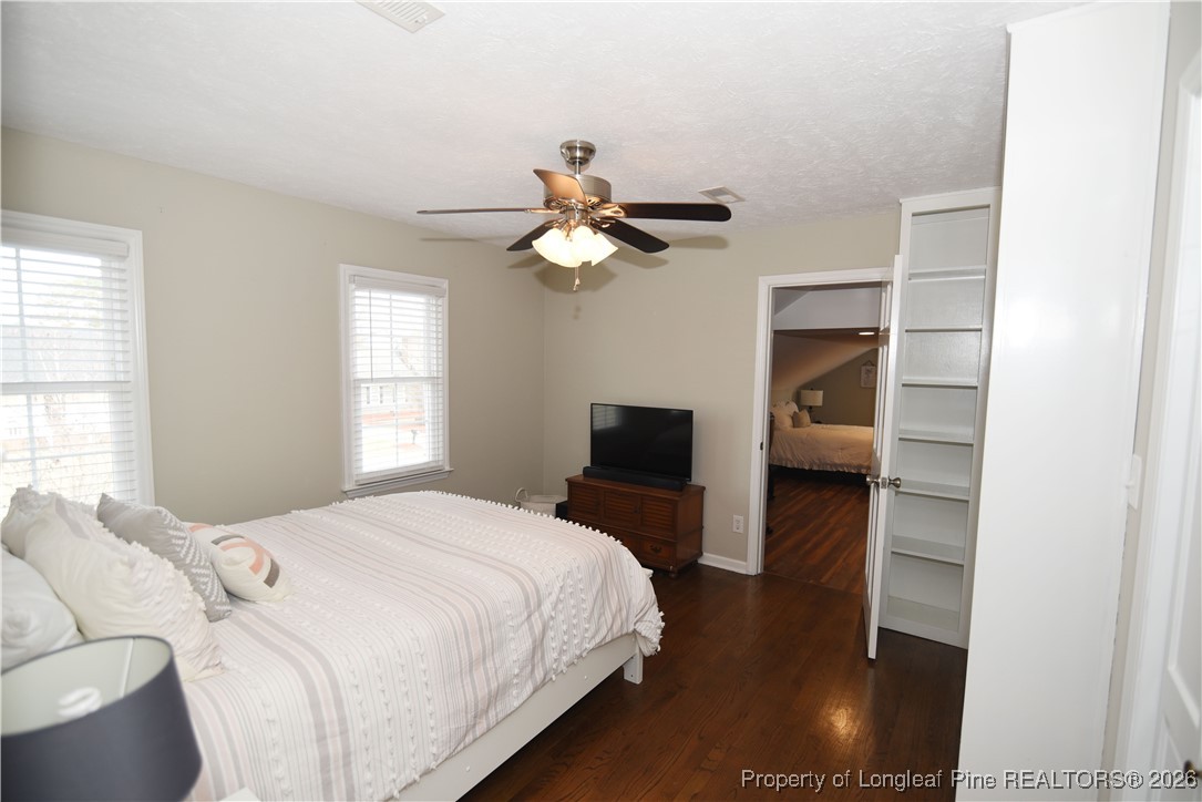 210 Tartan Road Lumberton, NC 28358 - Photo 28 of 38 a bedroom with a bed and a chandelier