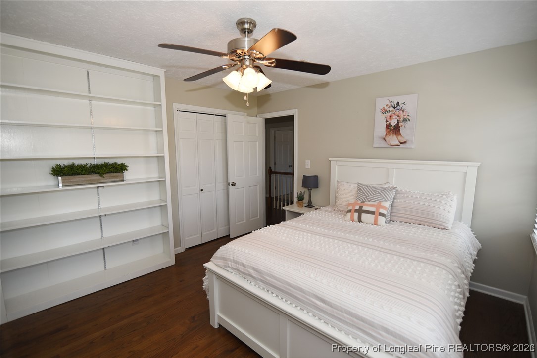 210 Tartan Road Lumberton, NC 28358 - Photo 29 of 38 a bedroom with a bed and a chandelier