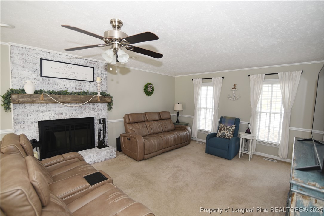 210 Tartan Road Lumberton, NC 28358 - Photo 4 of 38 a living room with furniture a window and a fireplace