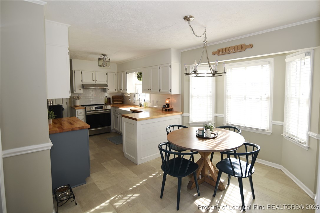 210 Tartan Road Lumberton, NC 28358 - Photo 10 of 38 a kitchen with a table and chairs in it