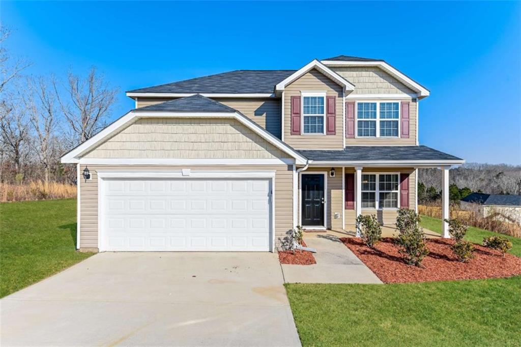 a front view of a house with a yard and porch