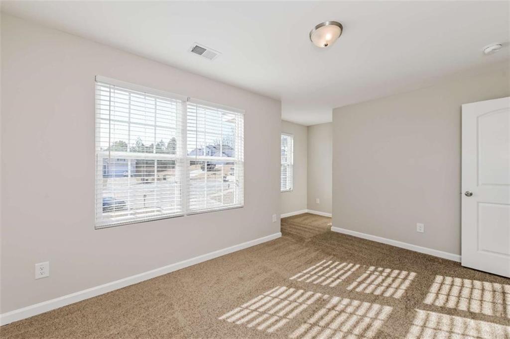 40 Tuesday Court Covington, GA 30016 - Photo 17 of 20 a view of an empty room with a window
