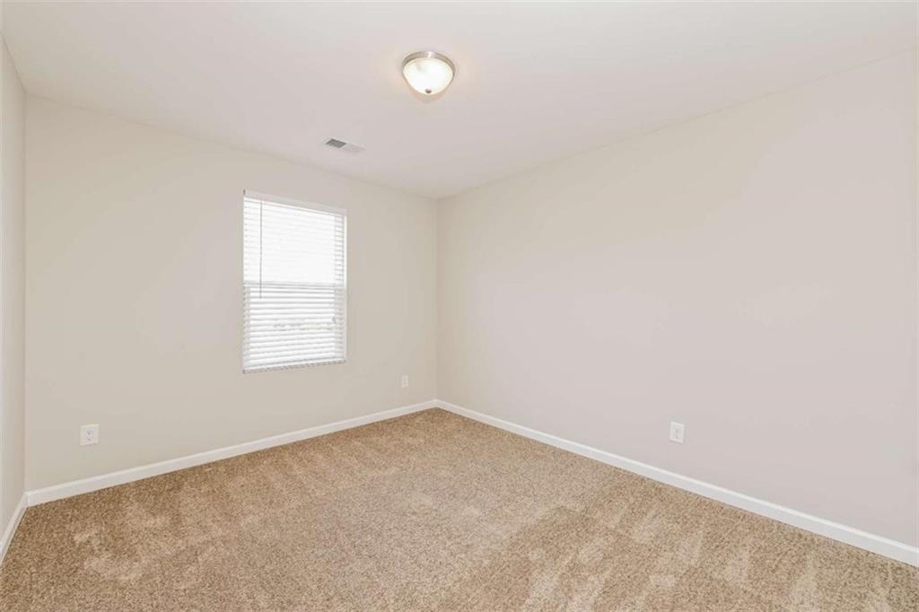 40 Tuesday Court Covington, GA 30016 - Photo 18 of 20 an empty room with a window