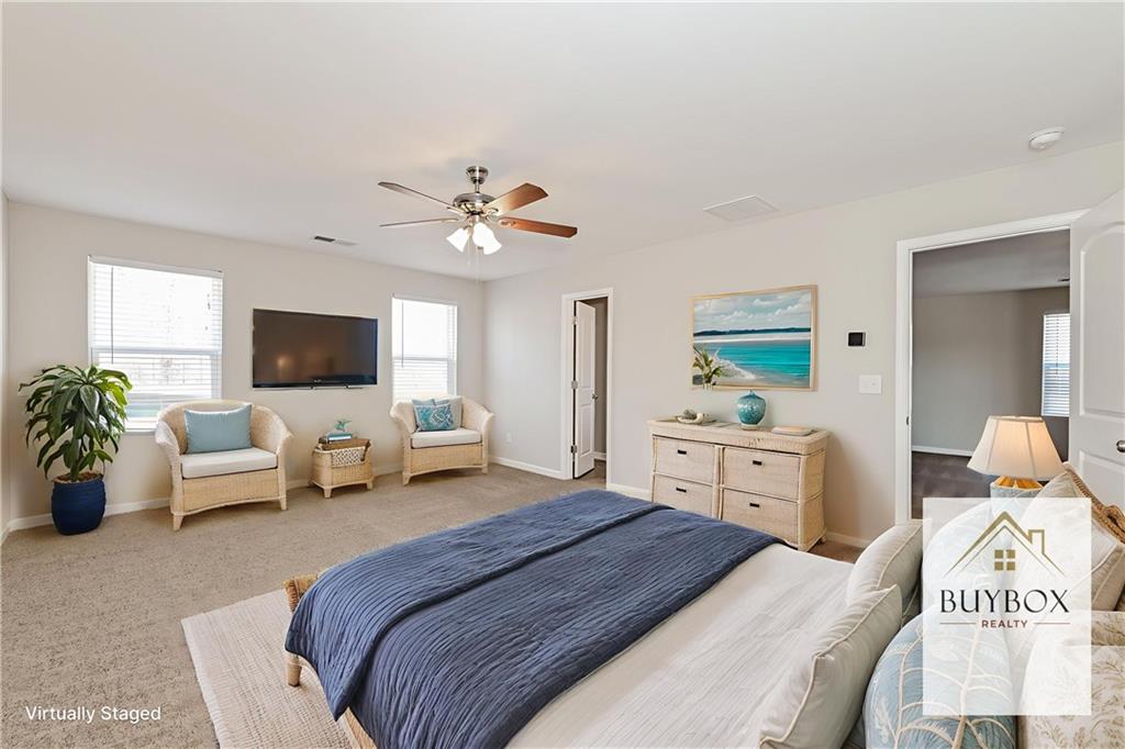 40 Tuesday Court Covington, GA 30016 - Photo 7 of 20 a bedroom with a bed and a flat screen tv