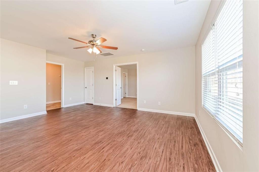 40 Tuesday Court Covington, GA 30016 - Photo 9 of 20 wooden floor in an empty room with a window