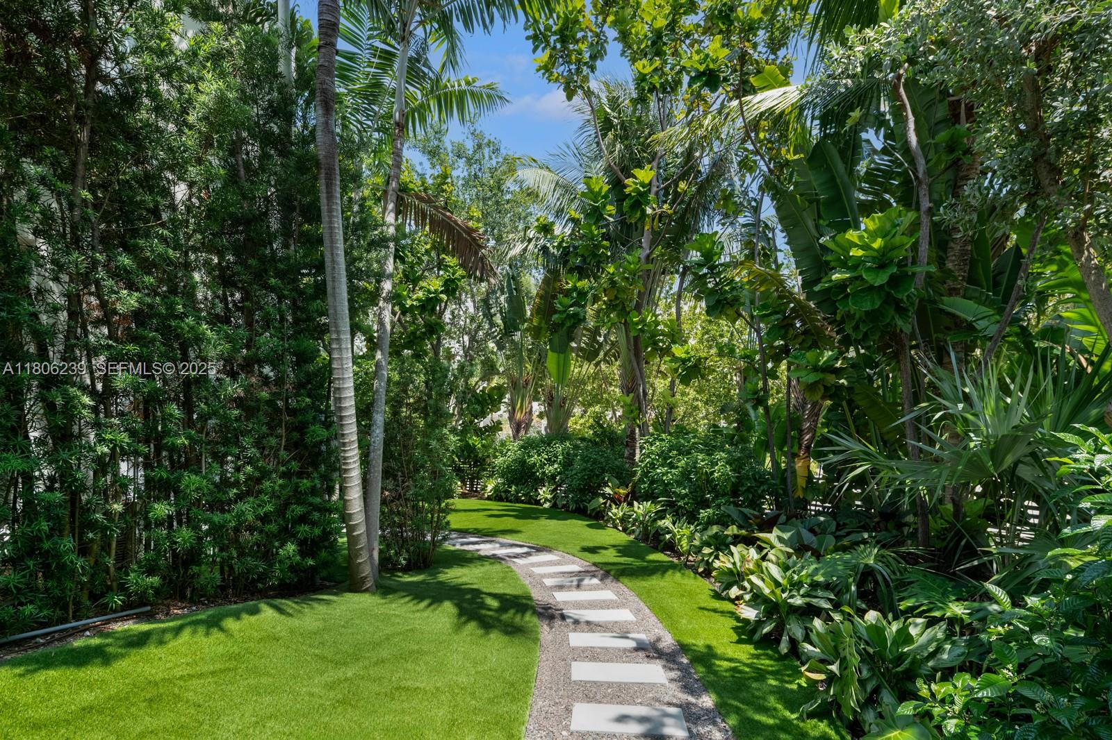 4700 Meridian Avenue Miami Beach, FL 33140 - Photo 7 of 64 a view of a yard with plants and large trees