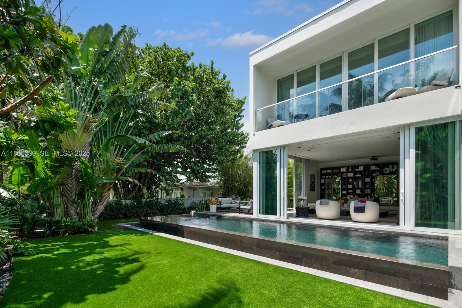 4700 Meridian Avenue Miami Beach, FL 33140 - Photo 10 of 64 a view of a swimming pool with two chairs in a patio