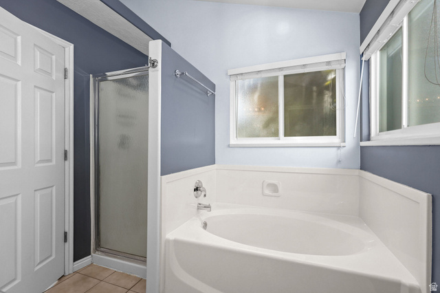 142 East 2675th Street South Clearfield, UT 84015 - Photo 22 of 49 Bathroom featuring a built-in corner soaking tub, separate shower with frosted glass enclosure, and white panel wainscoting