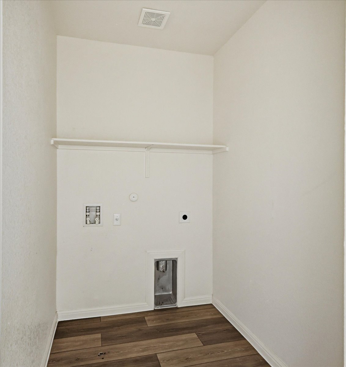 202 Peridot Pass Maxwell, TX 78656 - Photo 18 of 21 A well-appointed utility room features a built-in shelf and durable wood flooring.