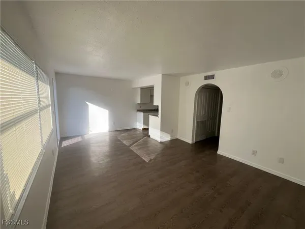 an empty room with windows and entrance