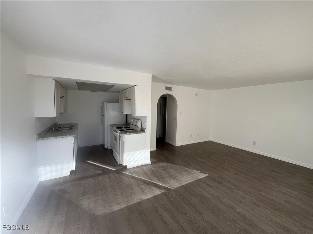 1919 Lillie Street, Unit H Fort Myers, FL 33916 - Photo 2 of 8 a view of kitchen and hall with wooden floor