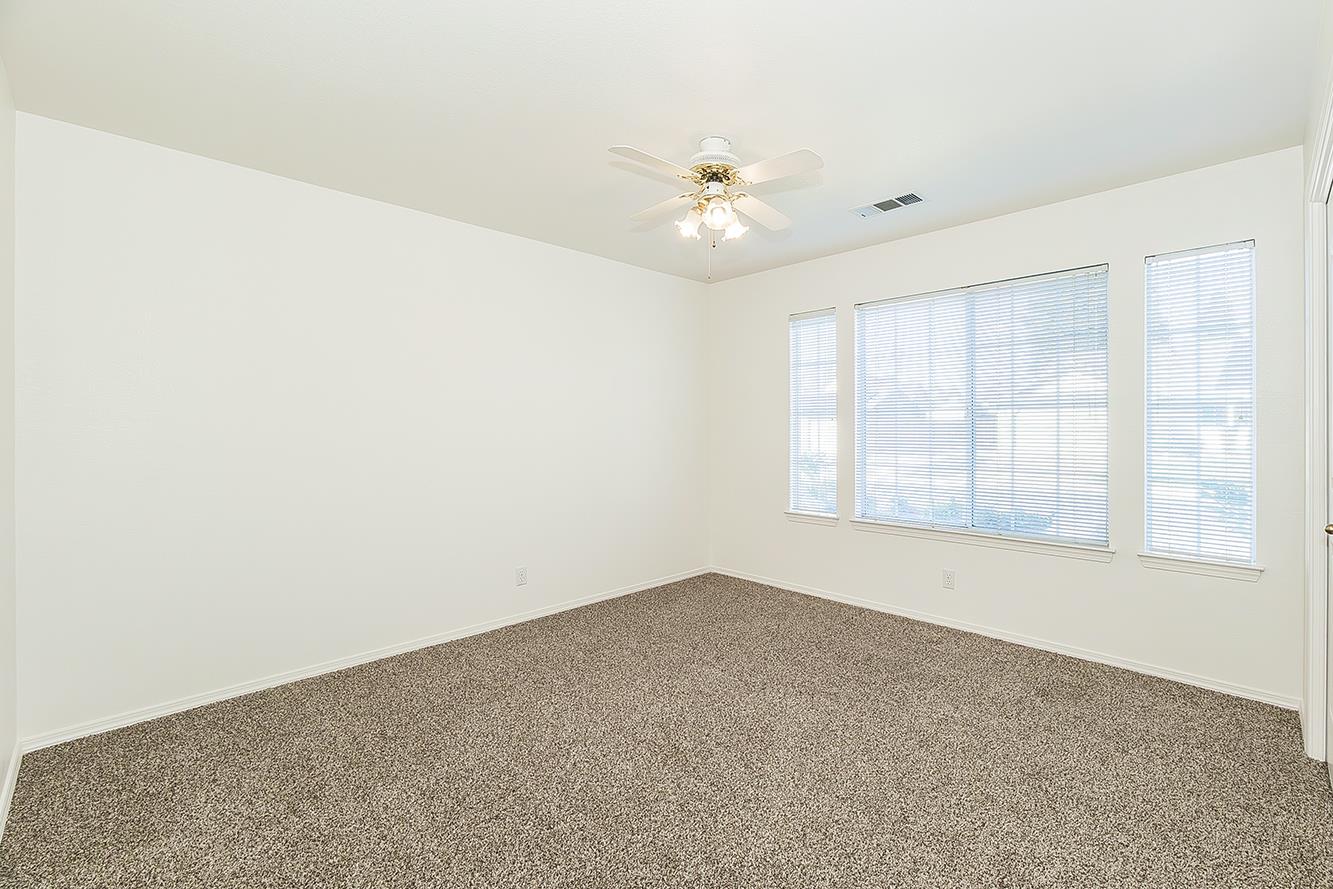 1415 West Riverglen Avenue Reedley, CA 93654 - Photo 22 of 48 an empty room with chandelier fan