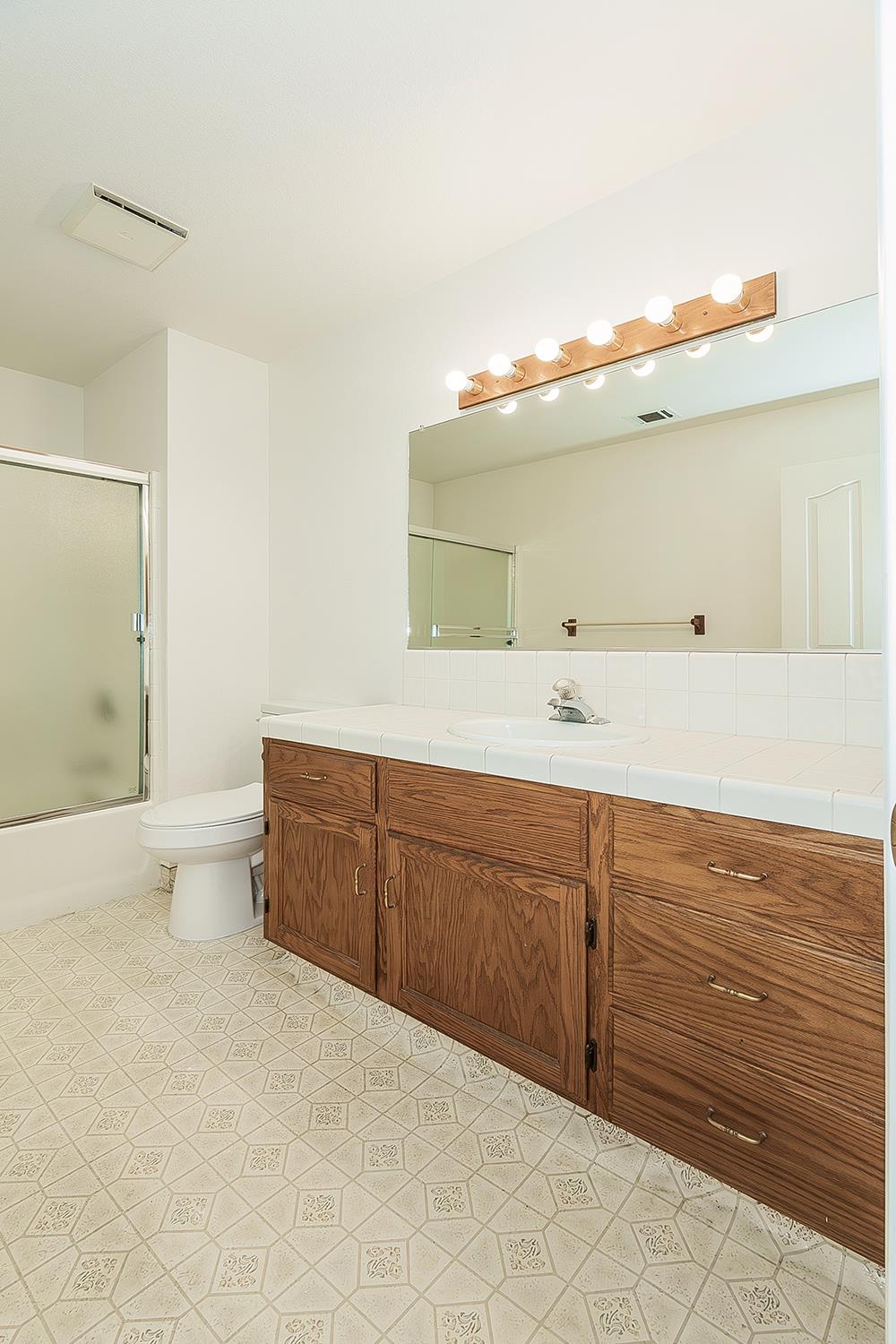 1415 West Riverglen Avenue Reedley, CA 93654 - Photo 24 of 48 a spacious bathroom with a sink and a toilet