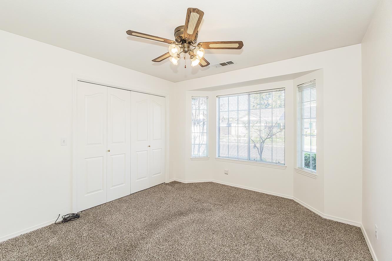 1415 West Riverglen Avenue Reedley, CA 93654 - Photo 26 of 48 a view of a livingroom with a ceiling fan and window