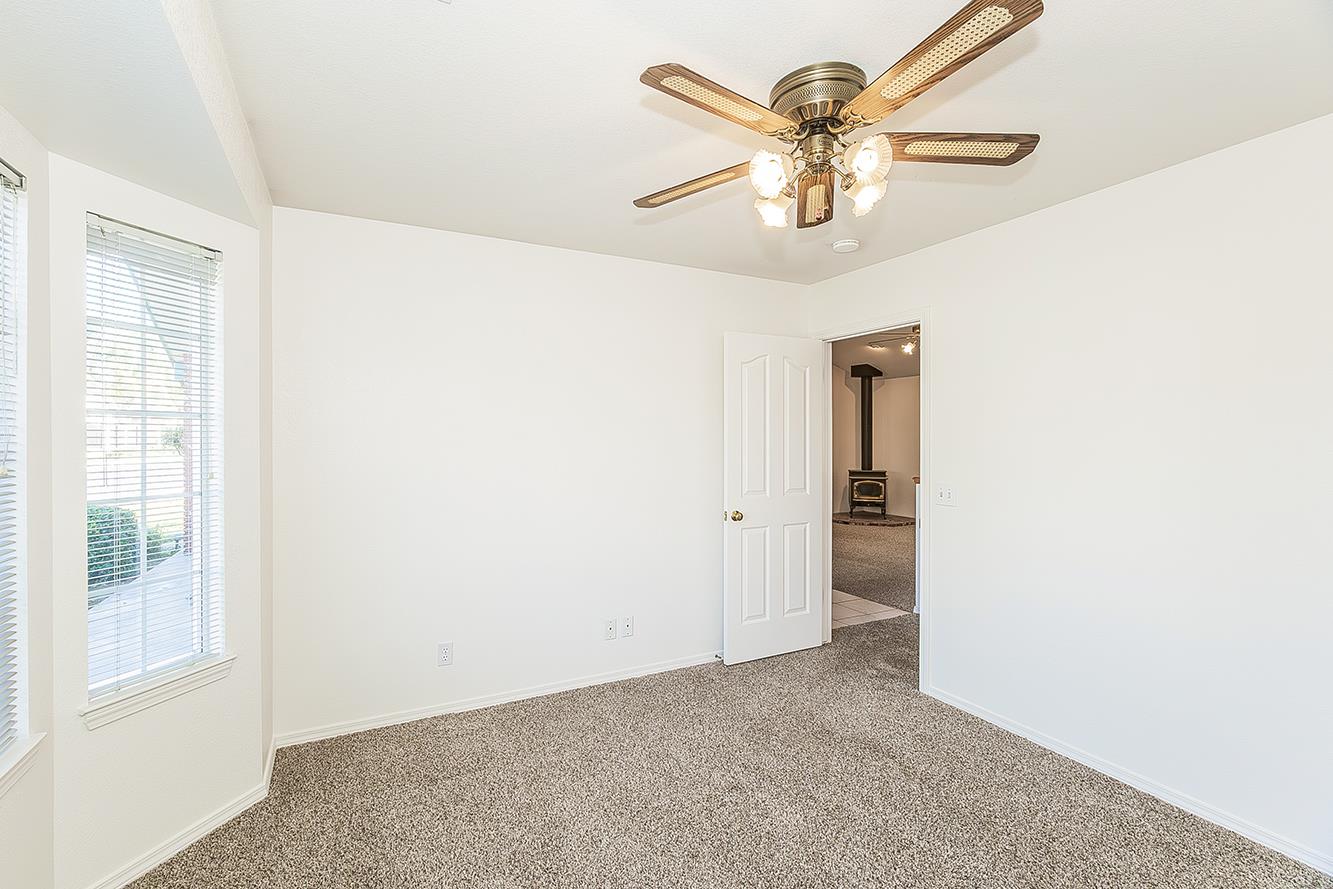 1415 West Riverglen Avenue Reedley, CA 93654 - Photo 27 of 48 a view of a livingroom with a ceiling fan and window