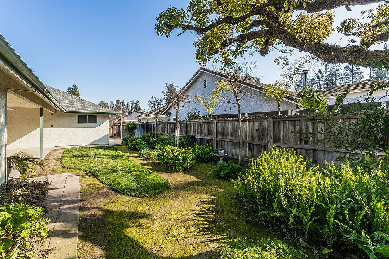 1415 West Riverglen Avenue Reedley, CA 93654 - Photo 34 of 48 a view of a backyard with plants and large tree