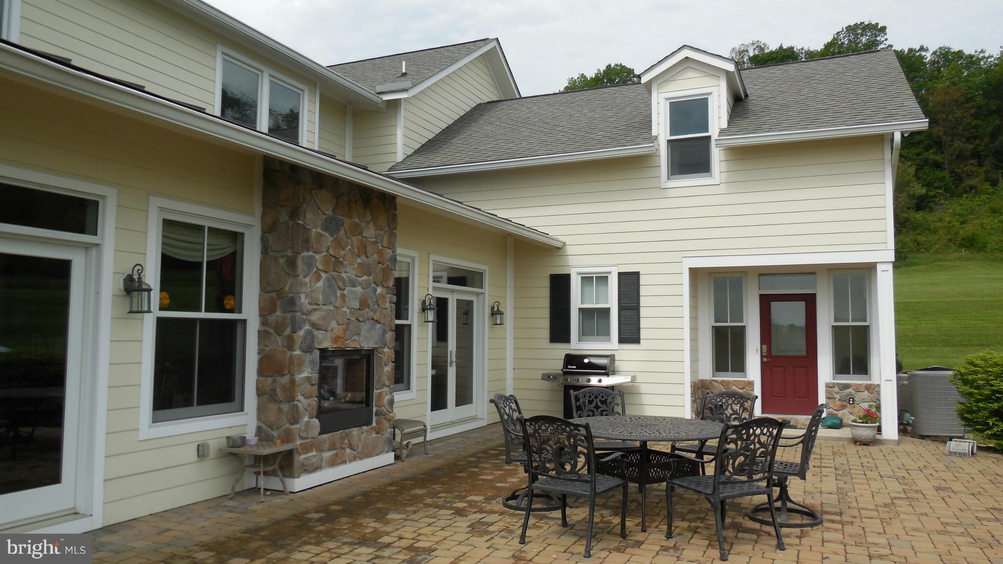 11601 Matthews Road Keymar, MD 21757 - Photo 5 of 30 a view of a patio with table and chairs and floor to ceiling window