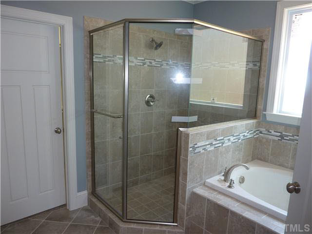 1345 Revolution Circle Raleigh, NC 27603 - Photo 11 of 20 a bathroom with a shower and a tub