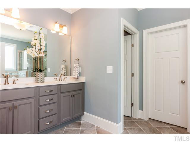 1345 Revolution Circle Raleigh, NC 27603 - Photo 12 of 20 a bathroom with a double vanity sink and mirror