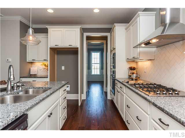1345 Revolution Circle Raleigh, NC 27603 - Photo 4 of 20 a kitchen with granite countertop a sink stove and cabinets