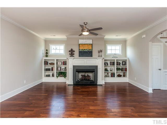 1345 Revolution Circle Raleigh, NC 27603 - Photo 9 of 20 a view of a livingroom with a fireplace a ceiling fan and wooden floor