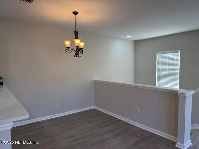 a room with wooden floor and white walls