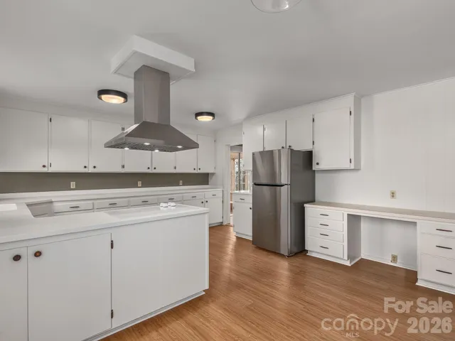 a kitchen with stainless steel appliances a stove refrigerator sink and cabinets