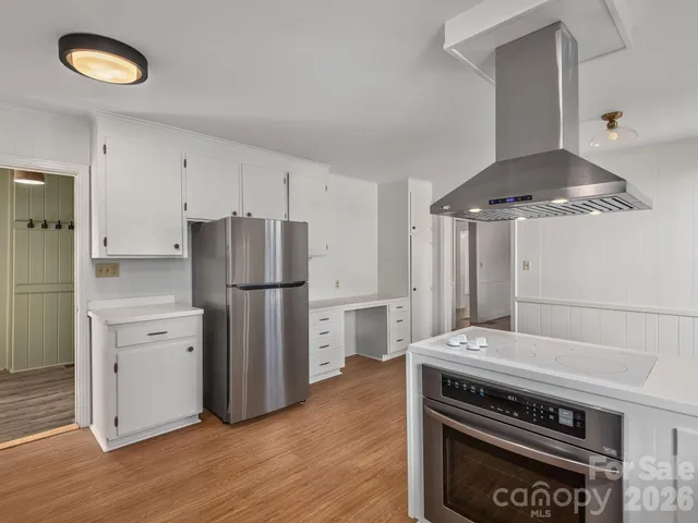 a kitchen with a stove and a refrigerator