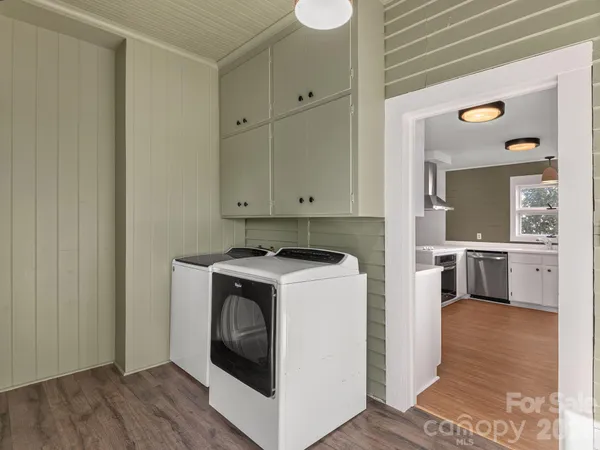a view of washer and dryer with wooden floor