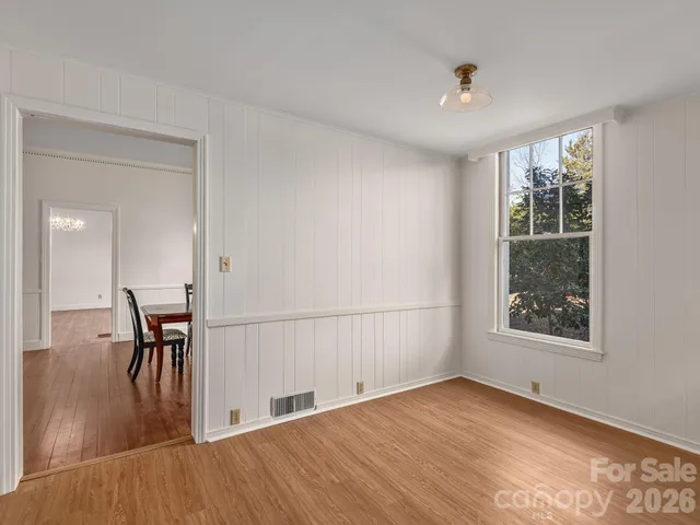 a view of a livingroom with wooden floor and a window