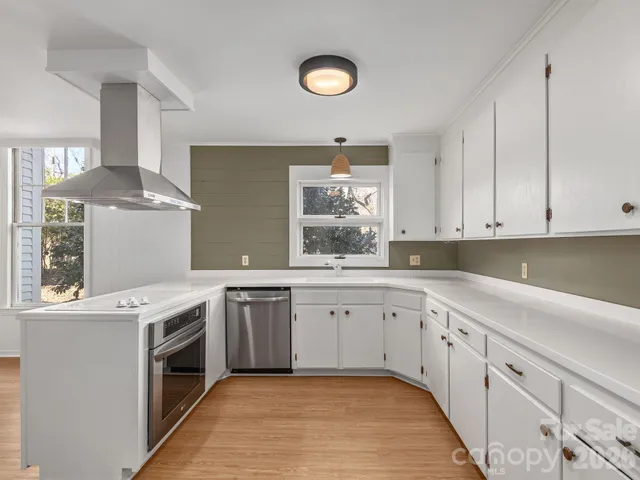 a kitchen with a sink stove and cabinets