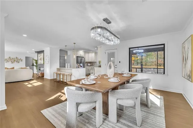 a view of a dining room with furniture and a chandelier