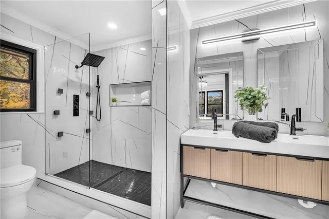 a bathroom with a shower sink and toilet