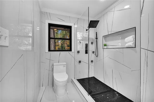 a bathroom with a toilet a sink and mirror