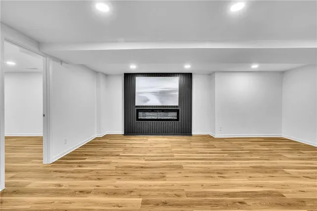 a view of an empty room and kitchen