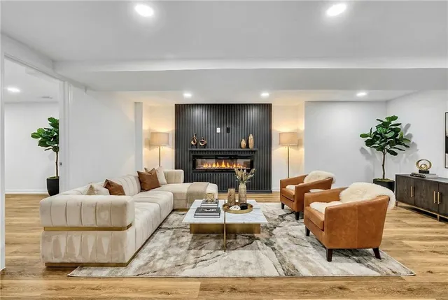 a living room with furniture and a potted plant