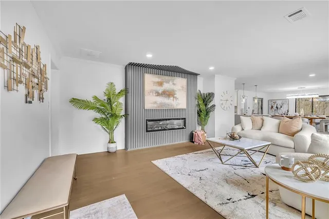a living room with furniture and a potted plant