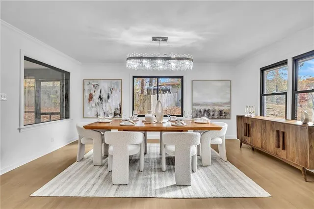 a view of a dining room with furniture wooden floor and chandelier