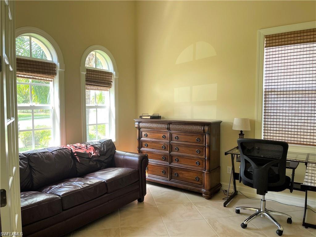 6557 Caldecott Drive Naples, FL 34113 - Photo 11 of 14 a living room with furniture and a window