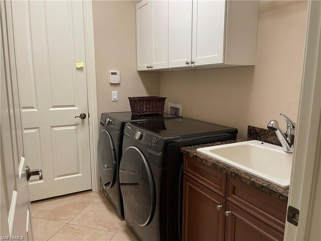 6557 Caldecott Drive Naples, FL 34113 - Photo 14 of 14 a utility room with dryer and washer