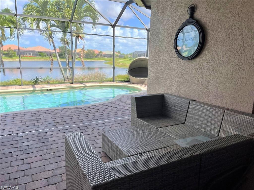 6557 Caldecott Drive Naples, FL 34113 - Photo 3 of 14 a living room with a couch and a clock