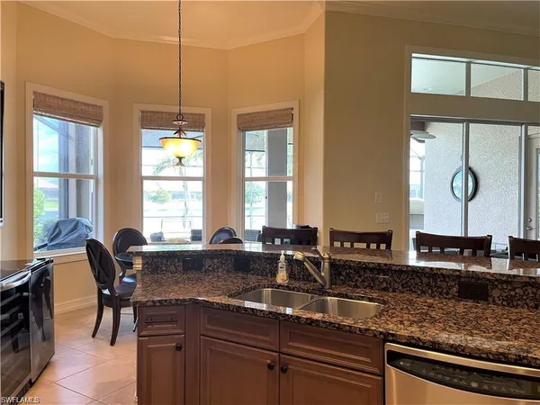 a kitchen with counter top space and windows