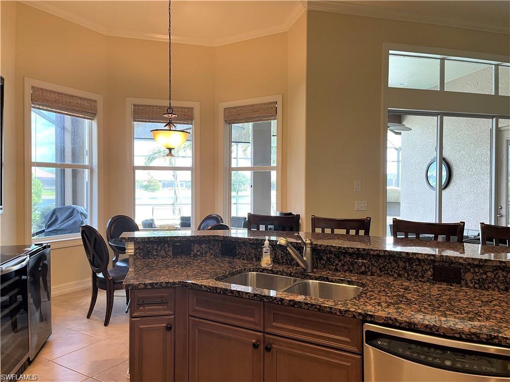 6557 Caldecott Drive Naples, FL 34113 - Photo 9 of 14 a kitchen with counter top space and windows