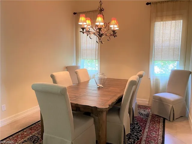 a dining room with furniture and chandelier