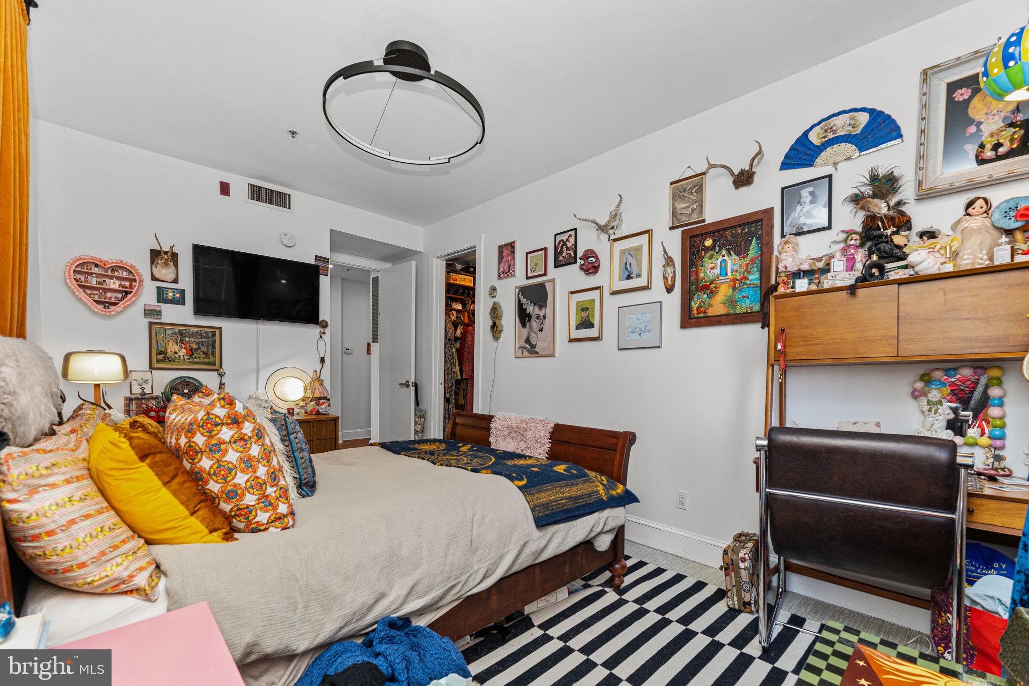 214 New Street, Unit G Philadelphia, PA 19106 - Photo 13 of 17 a bedroom with furniture and a flat screen tv