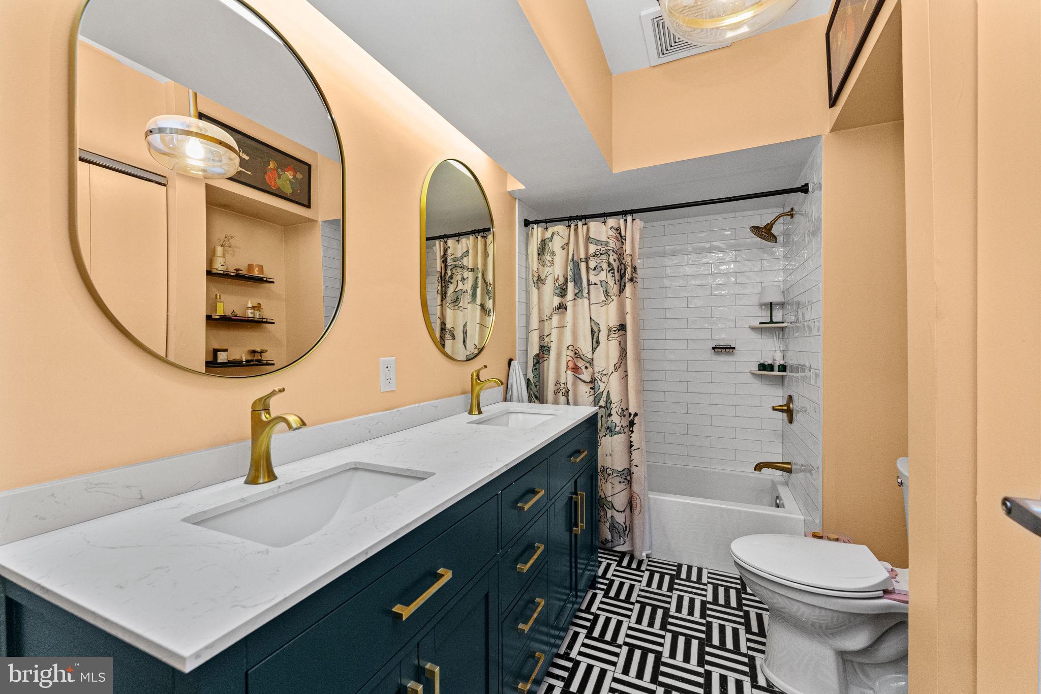 214 New Street, Unit G Philadelphia, PA 19106 - Photo 16 of 17 a bathroom with a sink a toilet and a mirror